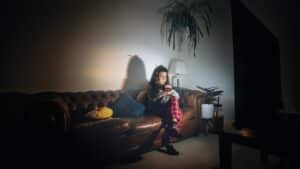 Person watching a scary video on a laptop in a dark room