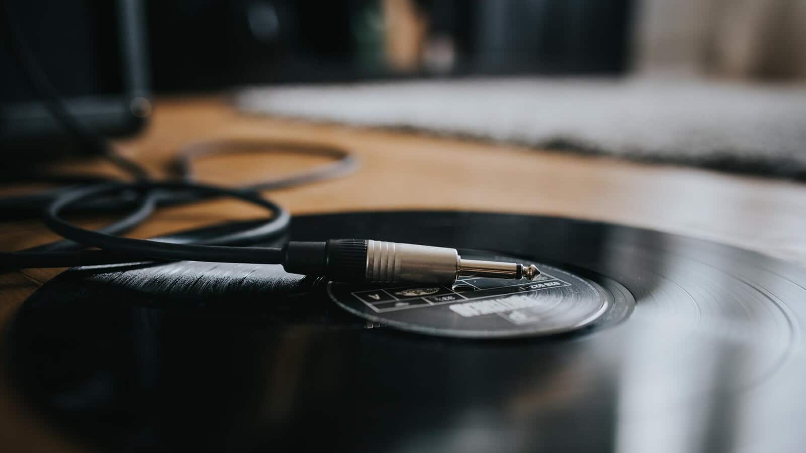 Headphones and a record on a desk for moody film music listening